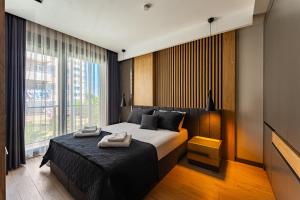 a bedroom with a bed with two towels on it at Bliss Residance in Altınkum +32 photos