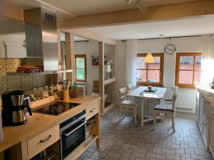 a kitchen with a table and a dining room at Apartment Waldblick by Interhome in Bleckede