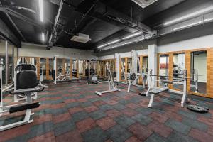 a gym with several treadmills and machines at Bliss Residance in Altınkum