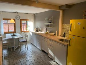 a kitchen with a yellow refrigerator and a table at Apartment Waldblick by Interhome in Bleckede