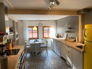 a kitchen with a table and a dining room at Apartment Waldblick by Interhome in Bleckede +16 photos