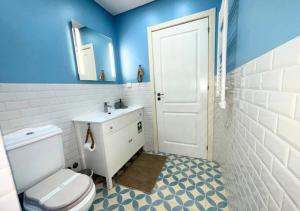 a bathroom with a white toilet and a sink at Casa na Aldeia in Melides +7 photos