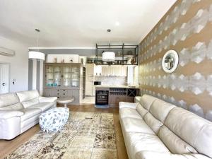 a living room with a couch and a kitchen at Olympia Sozopol in Sozopol