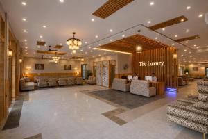 a lobby of a hotel with couches and a bar at Hotel The Luxury Delhi Airport in New Delhi