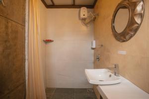 a bathroom with a sink and a mirror at Nivaant Villa by StayAtlas in Igatpuri +29 photos