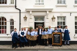 a group of people standing in front of a building at The Swan in Arundel
