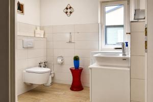 a bathroom with a toilet and a sink at Ferienhaus Alisch Fewo 2 in Warnemünde +10 photos