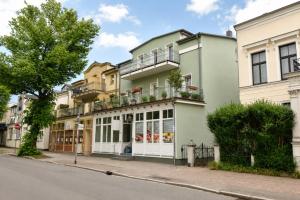 an apartment building with a store on a street at Ferienhaus Alisch Fewo 2 in Warnemünde
