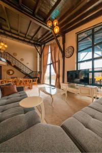 a living room with two couches and a tv at Monk By The Lake Sapanca in Sapanca