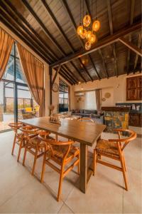 a dining room with a wooden table and chairs at Monk By The Lake Sapanca in Sapanca