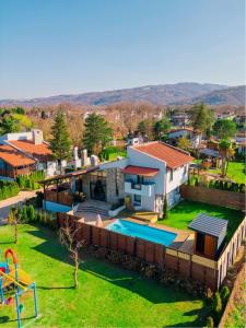 an aerial view of a house with a swimming pool at Monk By The Lake Sapanca in Sapanca