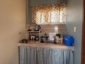 a kitchen counter with a sink and a window at Maru Vibe Studio unit in San Juan