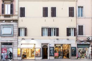 a building in a city with shops on a street at Tritone 91 Apartments in Rome