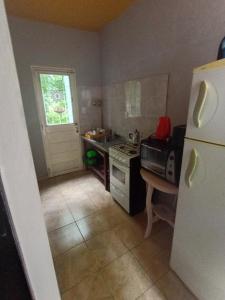 a kitchen with a stove and a refrigerator in it at Siempre verde3 in Merlo