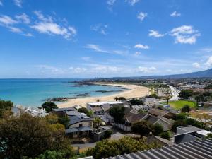 a view of a beach with houses and the ocean at Amazing View Villa, Sleeps 9 in Gordonʼs Bay