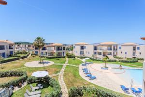 an aerial view of an apartment complex with a swimming pool at Resitour - Aphrodite Beachfront in Pírgos Psilonérou
