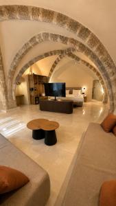 a large living room with a couch and a table at The Wine Suites in Rhodes Town