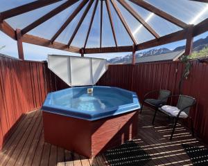 a hot tub on a deck with a gazebo at Engimyri Lodge in Akureyri