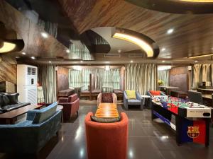 a room with couches and a table and a pool table at In One City Inn in Taichung