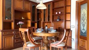 a dining room with a wooden table and chairs at la Casa de Flores in Tossa de Mar