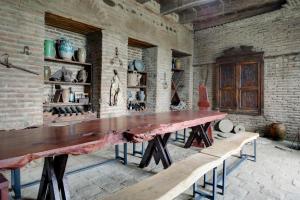 a large table in a room with a brick wall at Lurji Bani in Sighnaghi