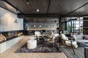 a living room with a couch and a table at TRIFORET alpin resort by Falkensteiner in Hinterstoder