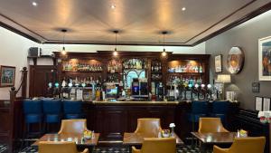 a bar with tables and chairs in a restaurant at Westlodge Hotel & Leisure Centre in Bantry