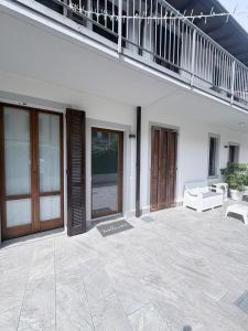 a white house with a patio and a balcony at Sweet & Home in Azzano San Paolo