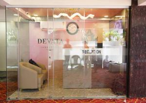 a window of a store with a chair and a table at DEVATA SUITES in Vijayawāda