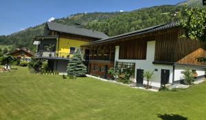 a large house with a lawn in front of it at Konis Ferienwohnung - barrierearm in Rangersdorf +35 photos