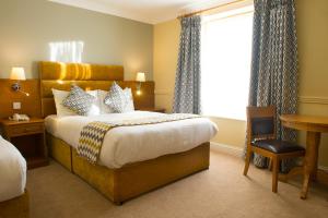 a hotel room with a bed and a window at Tralee Benners Hotel in Tralee