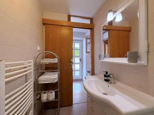 a white bathroom with a sink and a mirror at Apartments Nevenka K. in Čižići +84 photos