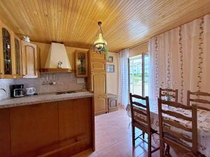 a kitchen with a counter and a table and chairs at Apartments Nevenka K. in Čižići