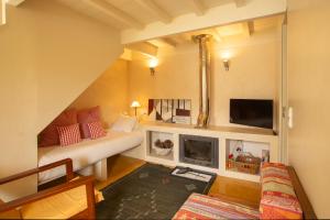 a living room with a couch and a fireplace at Estúdio 24 na Boavista, JAMBA House in Porto