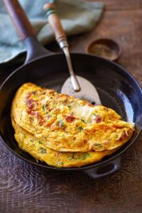 an omelet in a frying pan on a table at Haapsi Hideaway Garden Cabin in Haapsi +21 photos