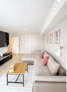 a living room with a couch and a table at WRW Airport Residence in Otopeni