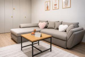 a living room with a couch and a table at WRW Airport Residence in Otopeni