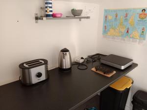 a desk with a toaster and a printer on it at argagnon 64 chambre sbd wc salon privés in Argagnon