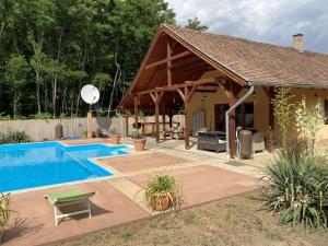 a house with a swimming pool and a pavilion at CUKROS Villa in Cserkeszőlő