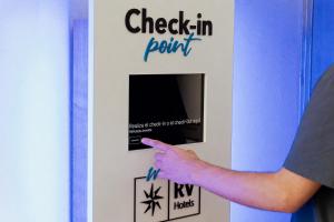 a person pointing at a sign that reads check in point at RVHotels Vila de Tossa in Tossa de Mar