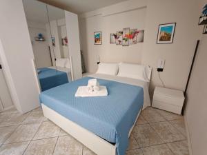 a bedroom with a bed with two towels on it at Antonella's sweet home AIRPORT ORIO AL SERIO in Stezzano +6 photos