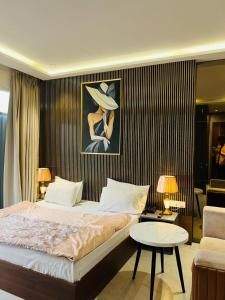 a bedroom with a large bed and a living room at Hotel Cassa Inn in Bathinda +11 photos