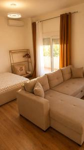 a living room with a couch and a bed at Sunset Terrace in Durrës