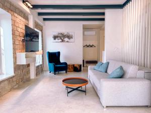 a living room with a couch and a table at Gloria Holiday - Casa Bianca in Piran