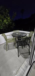 a table and two chairs sitting on a patio at Kos Cozy Home in Platánion