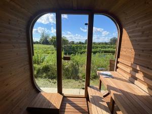 a room with two benches and a large window at Finest Retreats - Fletland Mill in Stamford