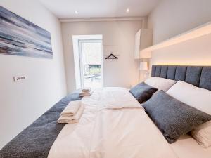 a bedroom with a large bed with two pillows at Gloria Holiday - Casa Bianca in Piran +76 photos