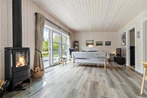 a living room with a fireplace and a couch at 8245-Knebel-Metholmvej-9 in Knebel