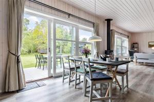a dining room with a table and chairs and a large window at 8245-Knebel-Metholmvej-9 in Knebel