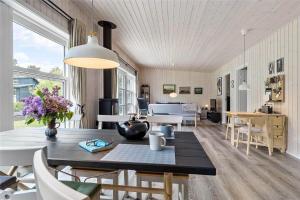 a dining room with a table and chairs at 8245-Knebel-Metholmvej-9 in Knebel